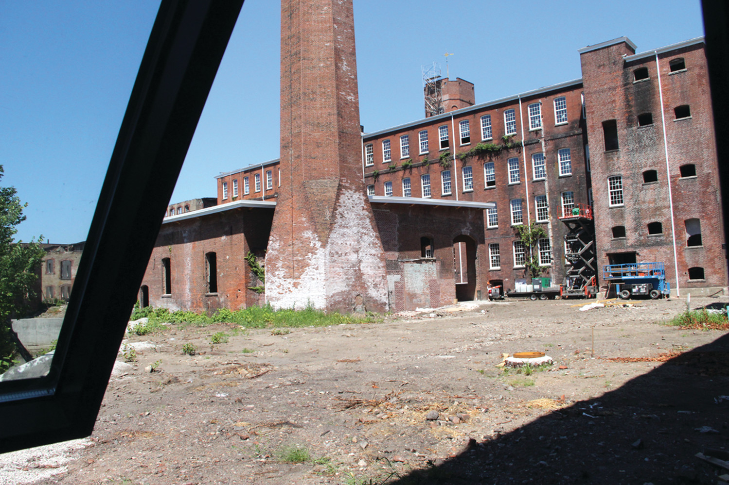 SOME CLEANUP REQUIRED: A courtyard at the Pontiac Mills property provides a rear view of a building on Knight Street. The mill property affords the opportunity for several different types of buildings. This smaller building here could perhaps become an office for rentals, of which there should be many, as the complex will eventually have 137 rental units.